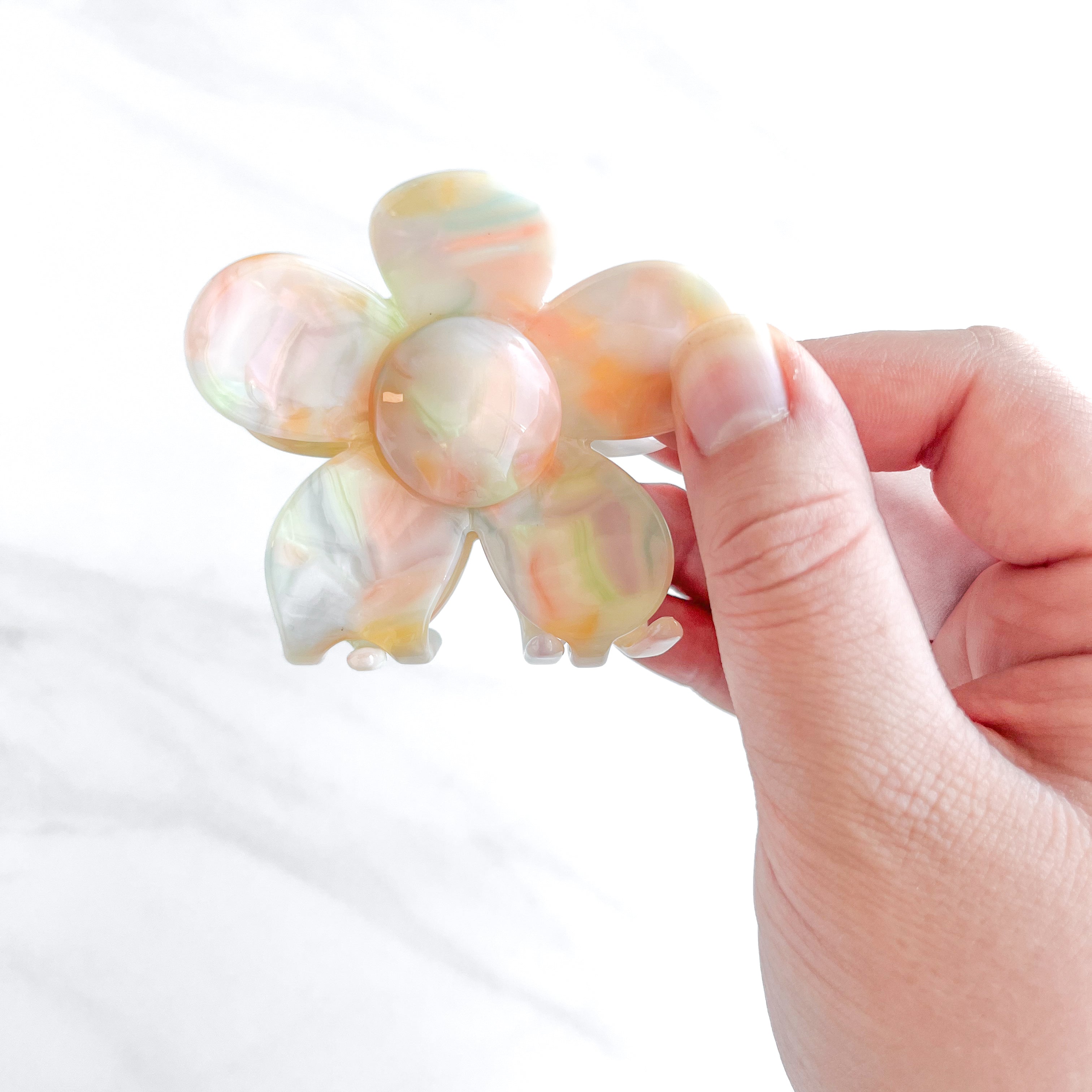 Hair claw clip in pink, yellow, or green marble in a flower shape