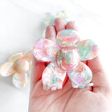 Hair claw clip in pink, yellow, or green marble in a flower shape