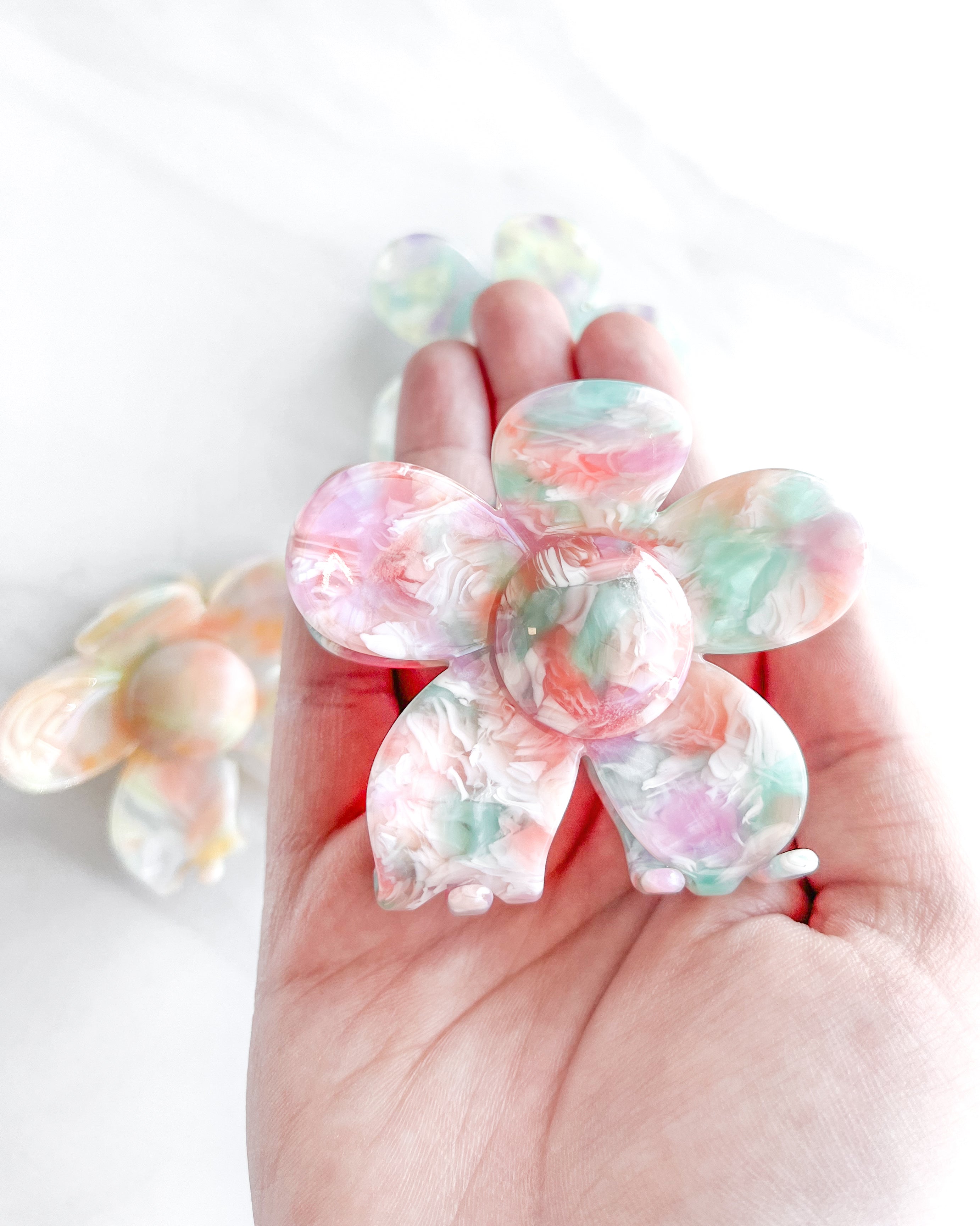 Hair claw clip in pink, yellow, or green marble in a flower shape