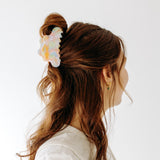 A woman with long hair styled perfectly with the On Cloud 9 Lilac Clip, showing both fashion and functionality.