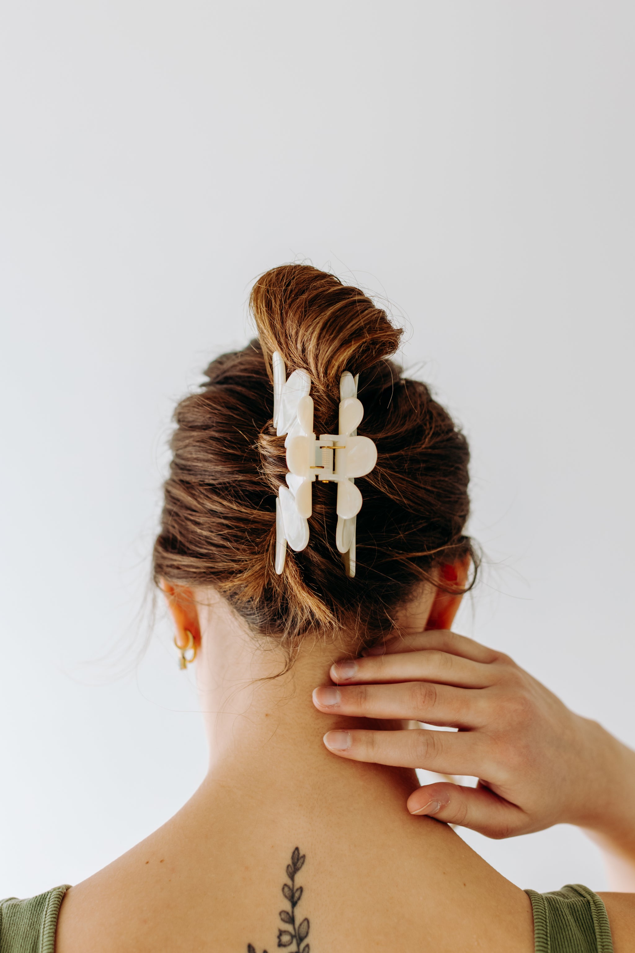A woman with long hair styled perfectly with the Hold On Tight Lilac Clip, showing both fashion and functionality.