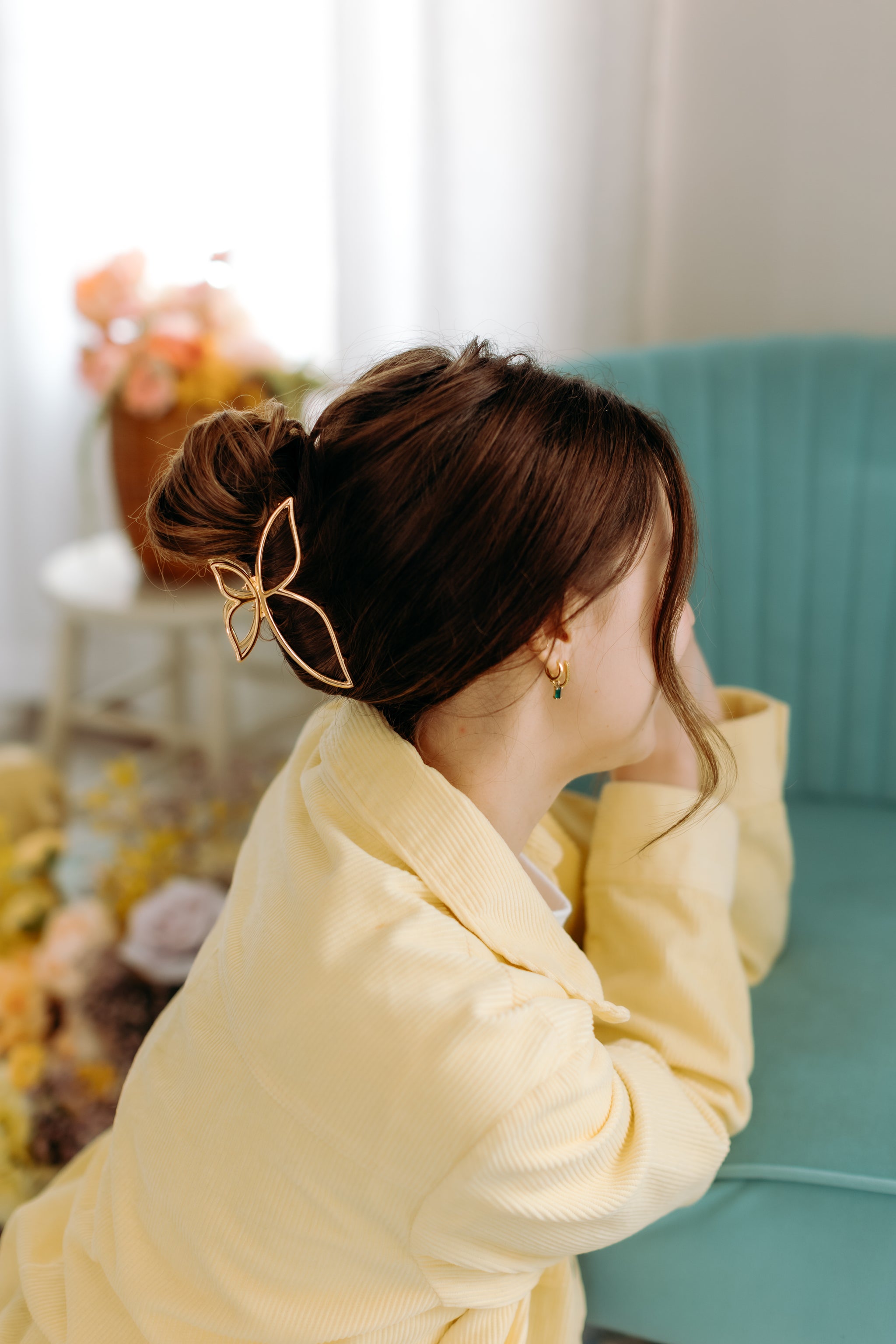 A woman with long hair styled perfectly with the Butterfly Kisses Lilac Clip, showing both fashion and functionality.