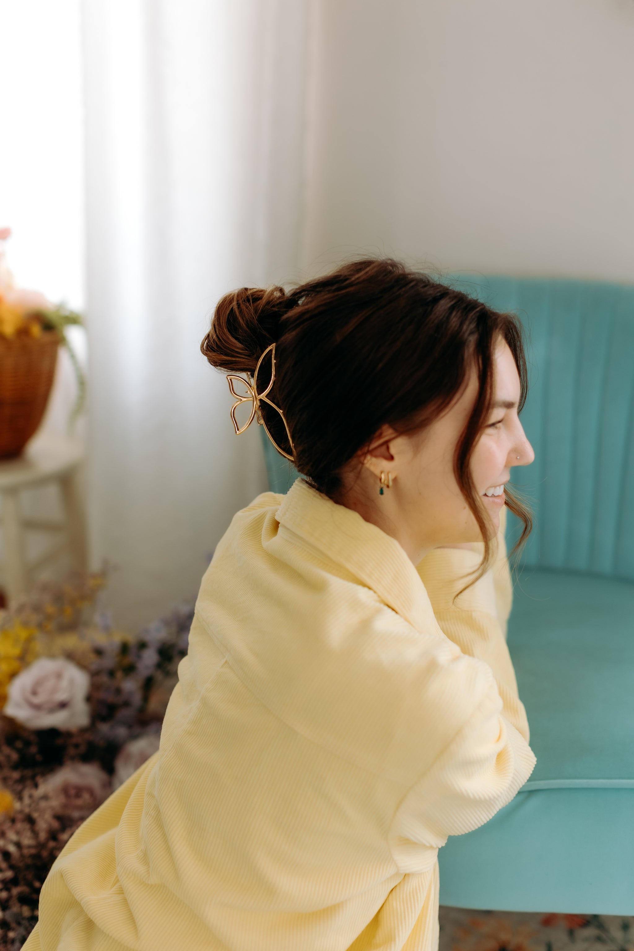 A woman with long hair styled perfectly with the Butterfly Kisses Lilac Clip, showing both fashion and functionality.
