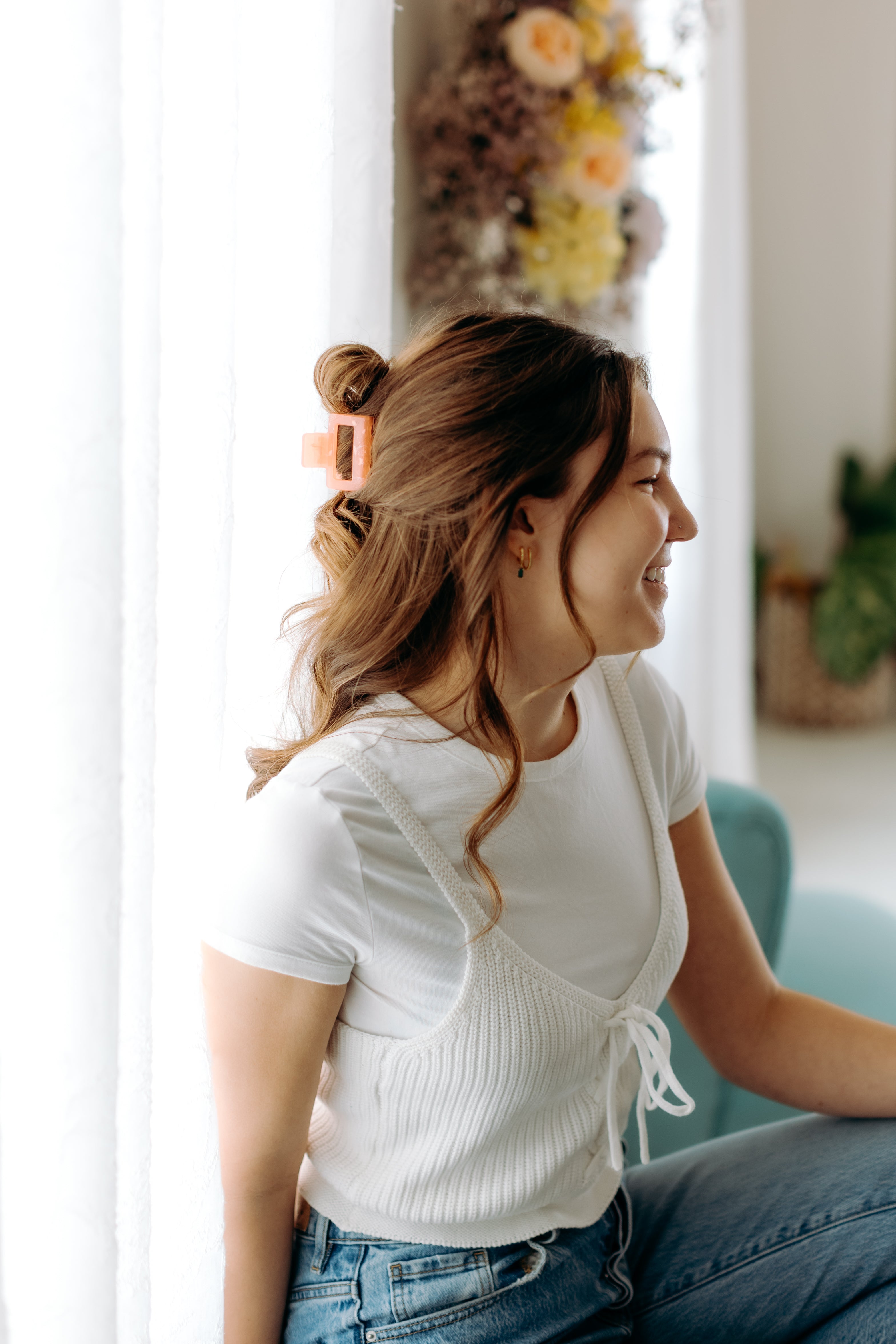 A woman with long hair styled perfectly with the Spring Fling Lilac Clip, showing both fashion and functionality.