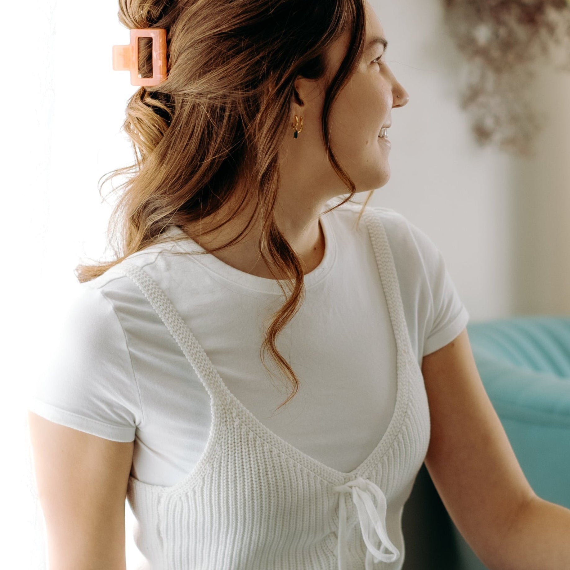 A woman with long hair styled perfectly with the Spring Fling Lilac Clip, showing both fashion and functionality.