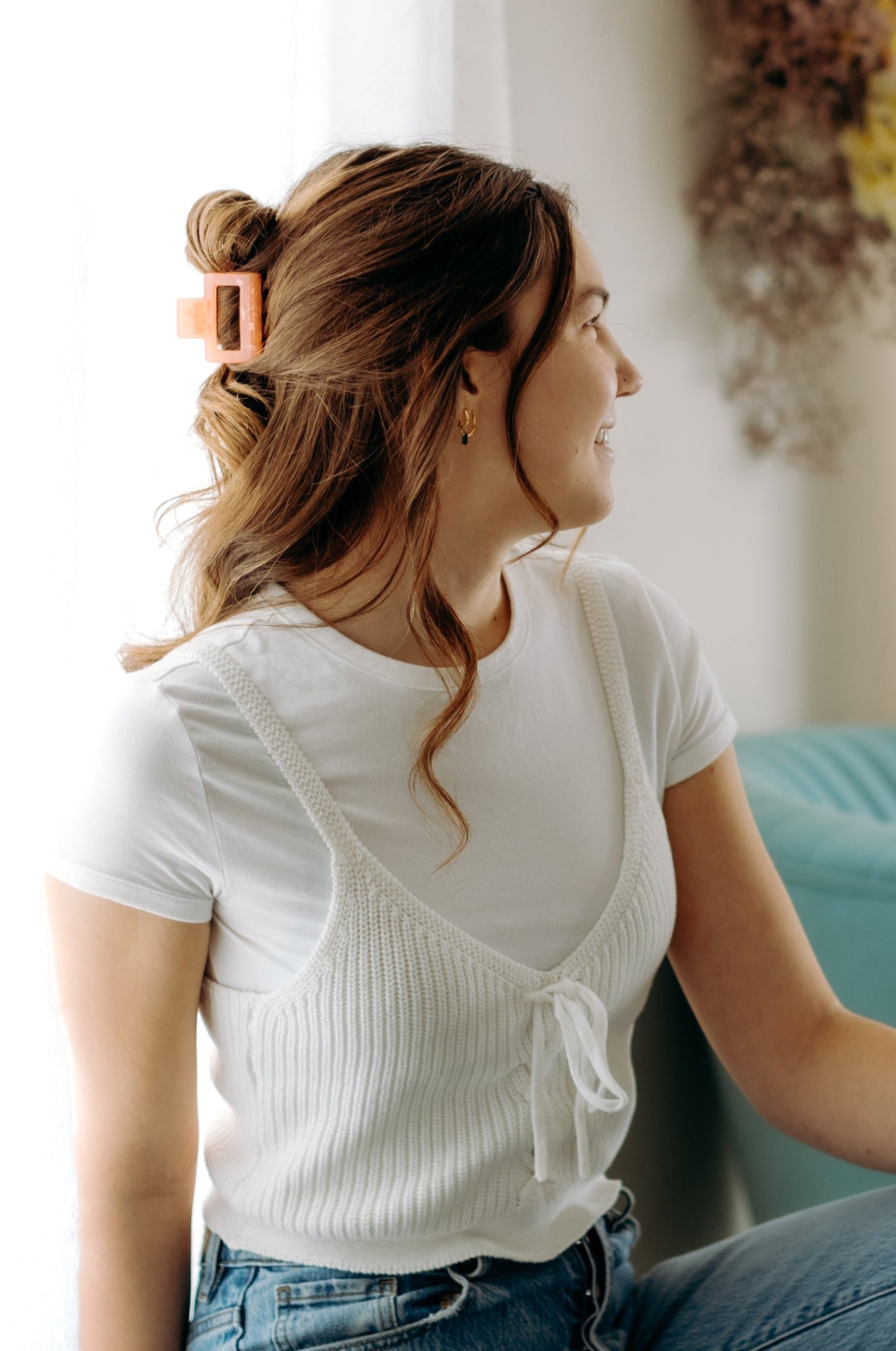 A woman with long hair styled perfectly with the Spring Fling Lilac Clip, showing both fashion and functionality.