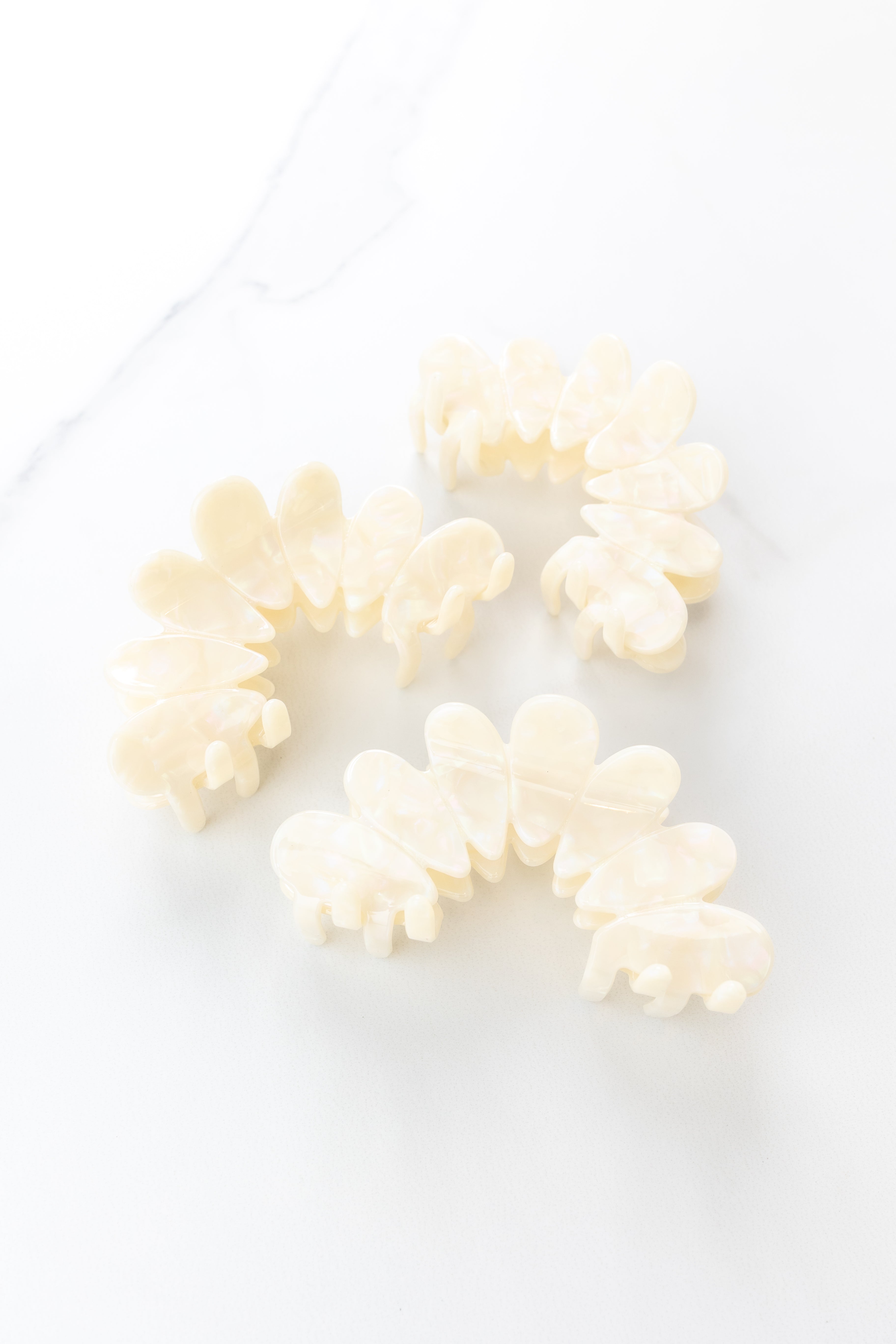Hold On Tight Lilac Clip featuring ivory marble almond scallop shapes, 4 inches long, glossy material, metal hinge closure, ideal for keeping hair styled and out of your face.
