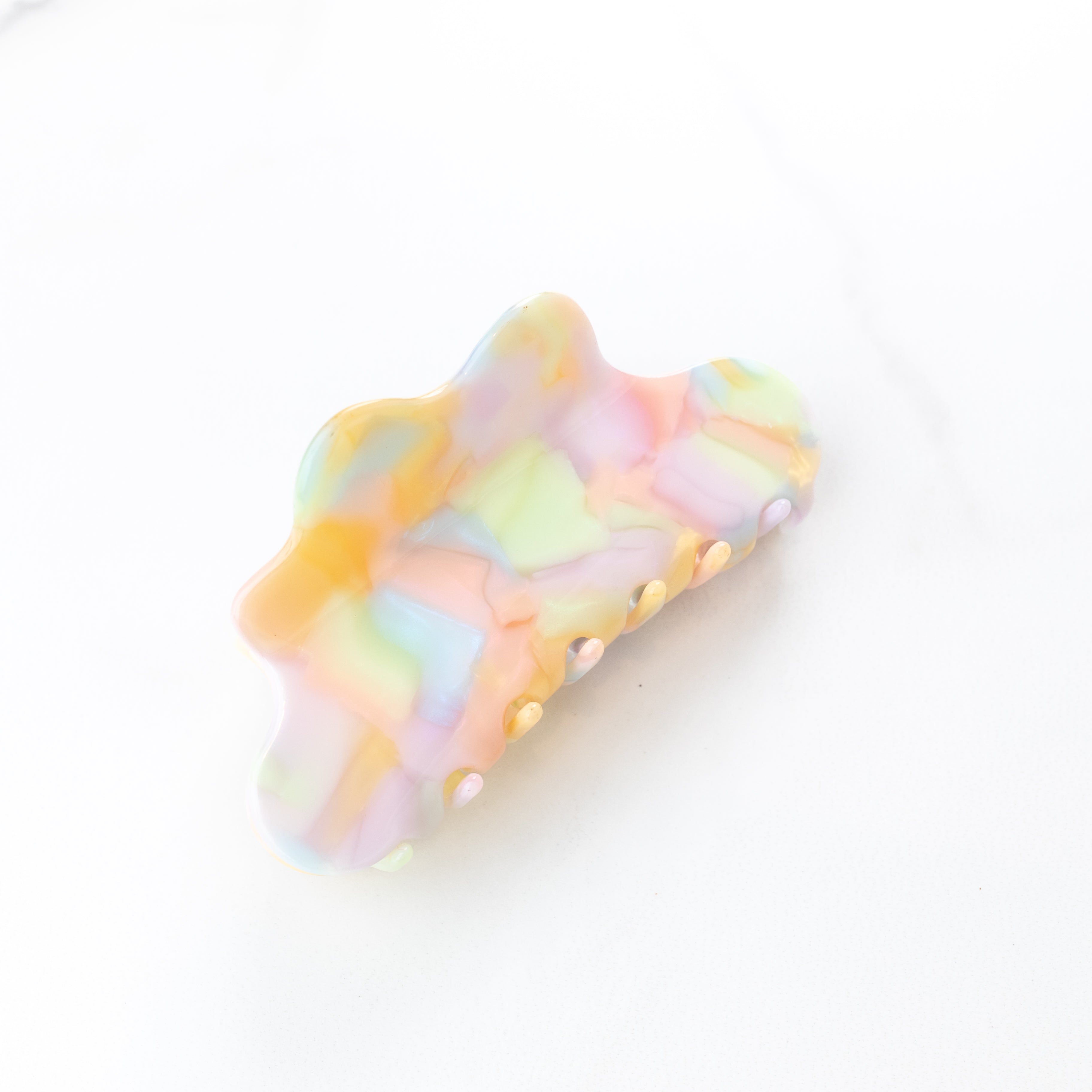 On Cloud 9 Lilac Clip featuring a pastel watercolor pattern with purple, orange, coral, green and blue, 4 inches long, glossy material, metal hinge closure, ideal for keeping hair styled and out of your face.