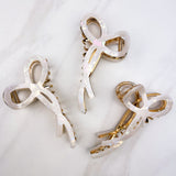 Spill the Tea Lilac Clip: A glossy, 5.5-inch claw clip with metal accents, featuring a hinge closure for a stylish, functional hair accessory.