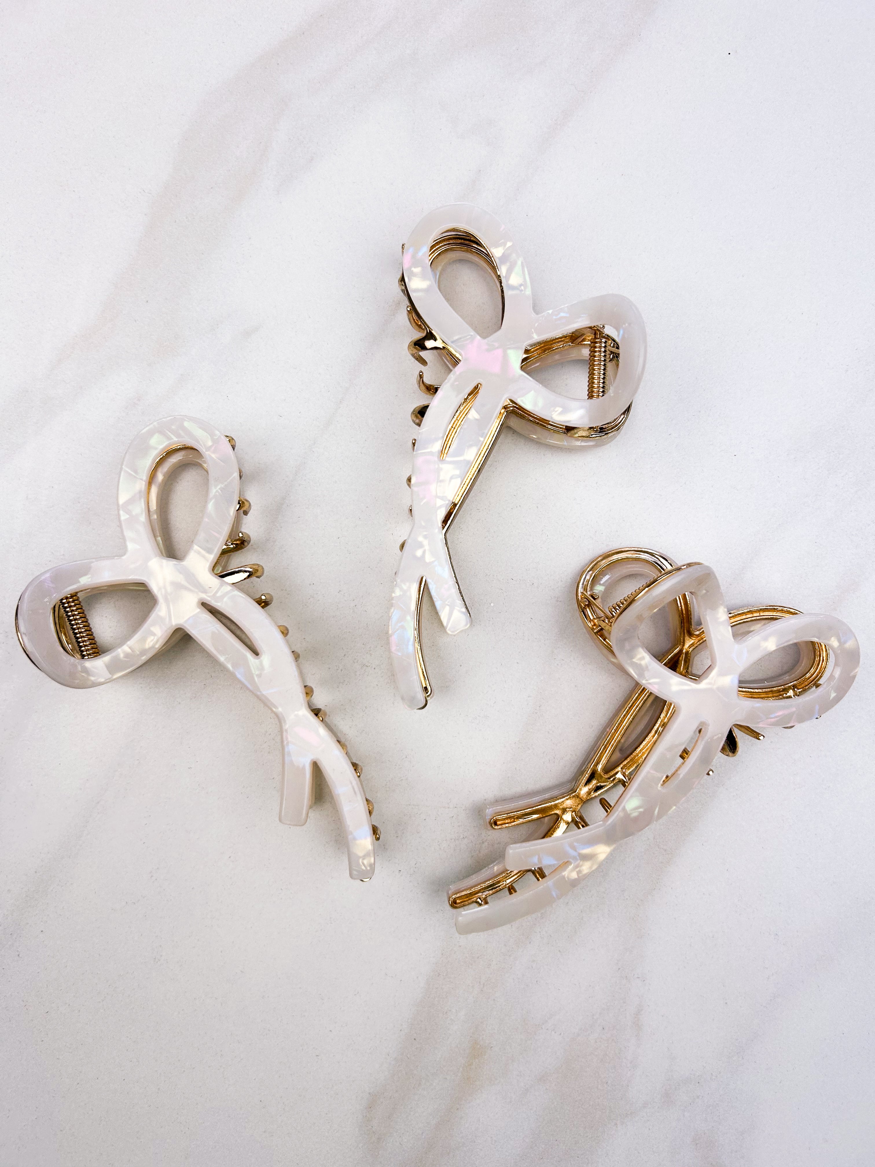 Spill the Tea Lilac Clip: A glossy, 5.5-inch claw clip with metal accents, featuring a hinge closure for a stylish, functional hair accessory.