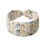 Heeler at Heart tan headband featuring Bluey characters, coordinating daisies and musical notes, crafted from a buttery-soft, ultra-stretchy poly-knit blend, the most comfortable hair accessory ever.