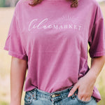 Adult berry colored shirt with Missouri state with the words "Handcrafted with Love in Springfield, MO" over the back, and "Lilac Market in script in the front with the outline of the setting sun