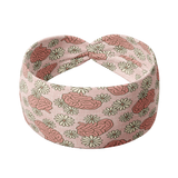 A pink headband with a floral pattern, designed for comfort and reliability. Features a versatile 3-in-1 twist style, sweat-absorbent fabric, and a comfortable fit.