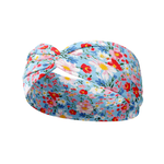 Zoey Floral on Sky Blue headband featuring a blue headband with pink, red and blue flowers, crafted from a buttery-soft, ultra-stretchy poly-knit blend, designed for versatility and comfort.