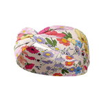 Sydney Floral on Beige headband featuring red, blue, yellow and pink flowers, crafted from a buttery-soft, ultra-stretchy poly-knit blend, designed for versatility and comfort.