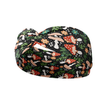 Woodland Wonder black headband featuring red and tan spotted mushrooms with flowers and greenery, crafted from a buttery-soft, ultra-stretchy poly-knit blend, designed for reliable non-slip comfort.