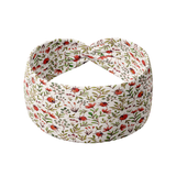 Lovebug white headband featuring flowers and ladybugs, crafted from a buttery-soft, ultra-stretchy poly-knit blend, designed for reliable non-slip comfort.