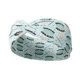 A blue headband featuring surgical tools and floral design. Functional and stylish for confidence and comfort. Versatile 3-in-1 twist style, sweat-absorbent, and non-slip. Designed in Springfield, MO.