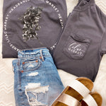 Adult grey colored shirt with grey lilac flowers with the words "Lilac Market Headbands" encircling them, and "Lilac Market" script on the front over a small pocket