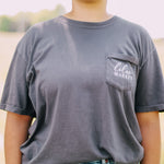 Adult grey colored shirt with grey lilac flowers with the words "Lilac Market Headbands" encircling them, and "Lilac Market" script on the front over a small pocket