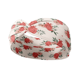 A pink headband with an anatomical heart and floral pattern, machine washable, ultra stretchy poly-knit blend, sweat absorbent, non-slip, and versatile 3-in-1 twist style. Designed for confidence and functionality.