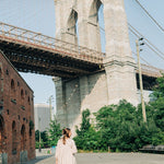 Woman with long hair in a bun, adorned with the Break A Leg Clip from The Sarah Wallace Collection, a marble and metal hair accessory.