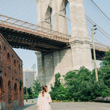 Woman with long hair in a bun, adorned with the Break A Leg Clip from The Sarah Wallace Collection, a marble and metal hair accessory.