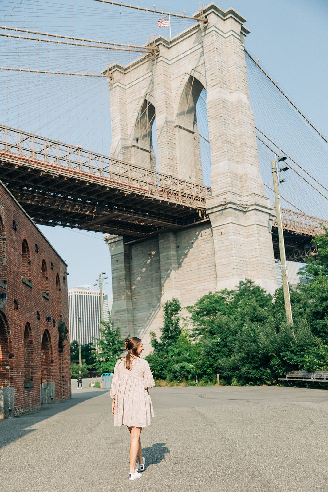 Woman with long hair in a bun, adorned with the Break A Leg Clip from The Sarah Wallace Collection, a marble and metal hair accessory.