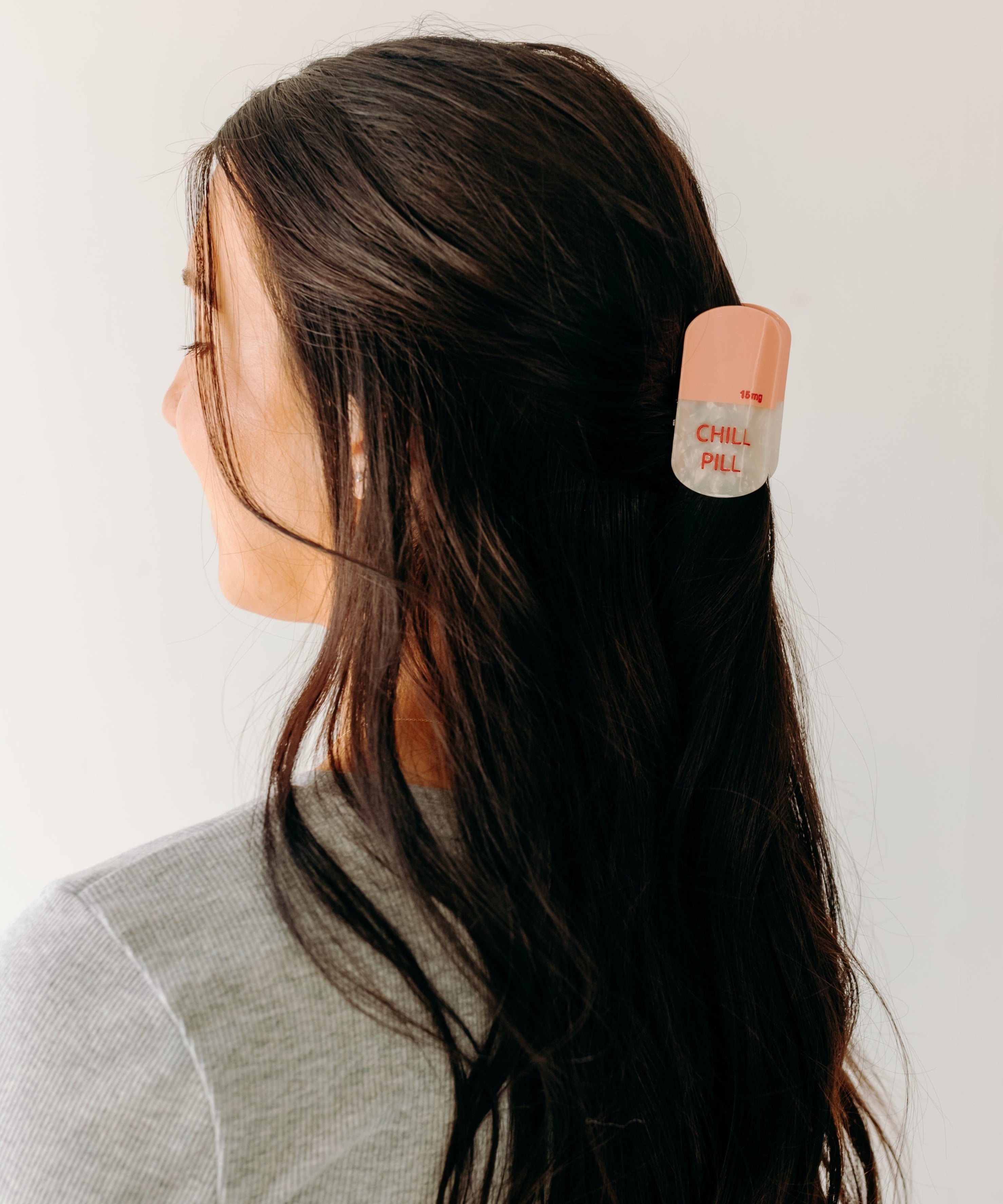 A woman with a Chill Pill Lilac Clip in her hair, showcasing the Lilac Clip - a 2.8 glossy claw clip for all hair types. Hinge closure keeps hair secure.
