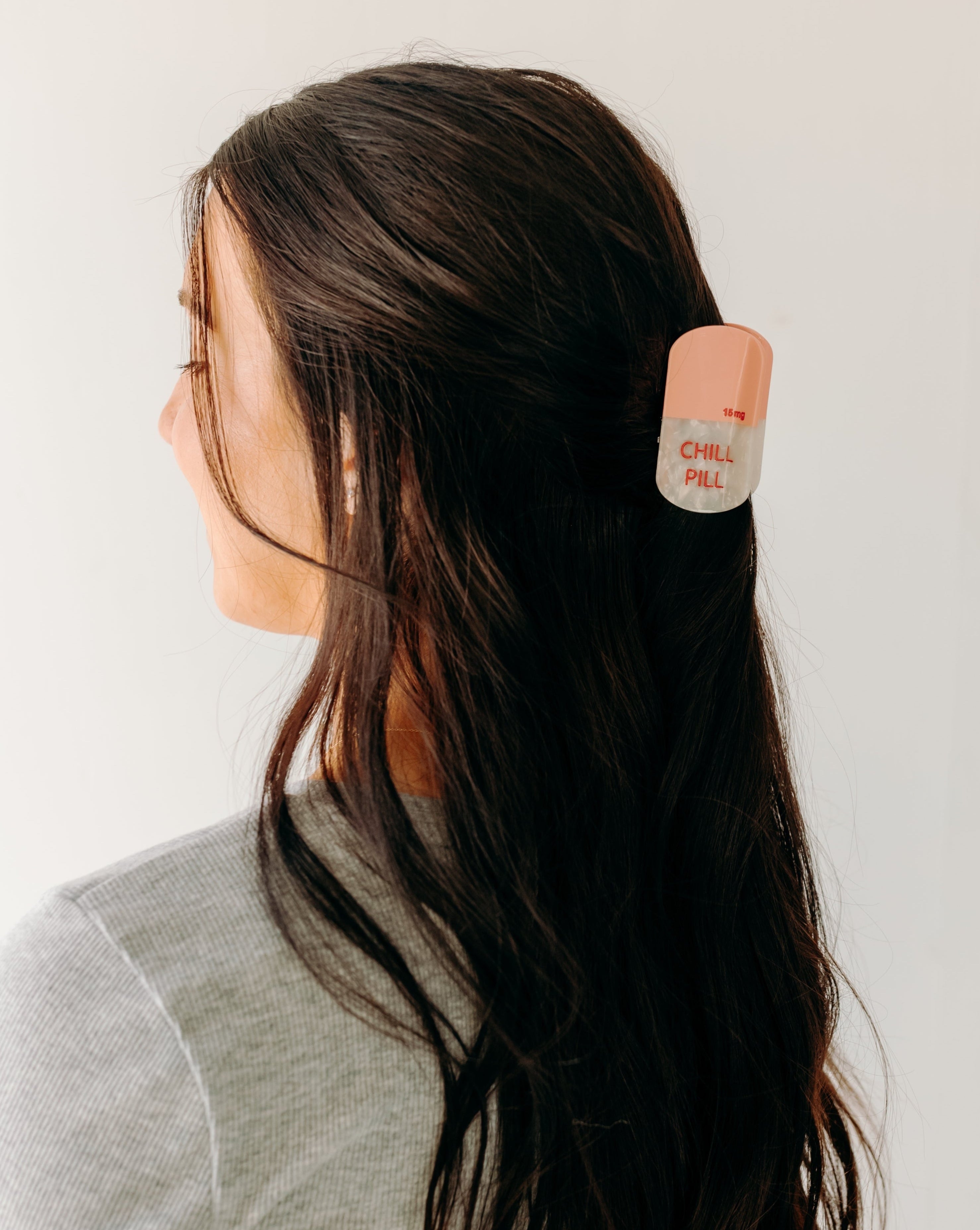 A woman with a Chill Pill Lilac Clip in her hair, showcasing the Lilac Clip - a 2.8 glossy claw clip for all hair types. Hinge closure keeps hair secure.