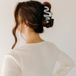 Woman wearing a light blue Comes in Waves Lilac Clip hair clip, showcasing her hairstyle.