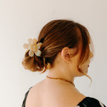 Woman wearing Time to Bloom Lilac Clip in her hair, close-up of flower hair accessory.