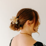 Woman wearing Time to Bloom Lilac Clip in her hair, close-up of flower hair accessory.
