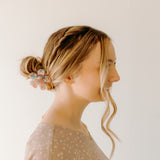 Woman wearing Time to Bloom Lilac Clip in her hair, close-up of flower hair accessory.