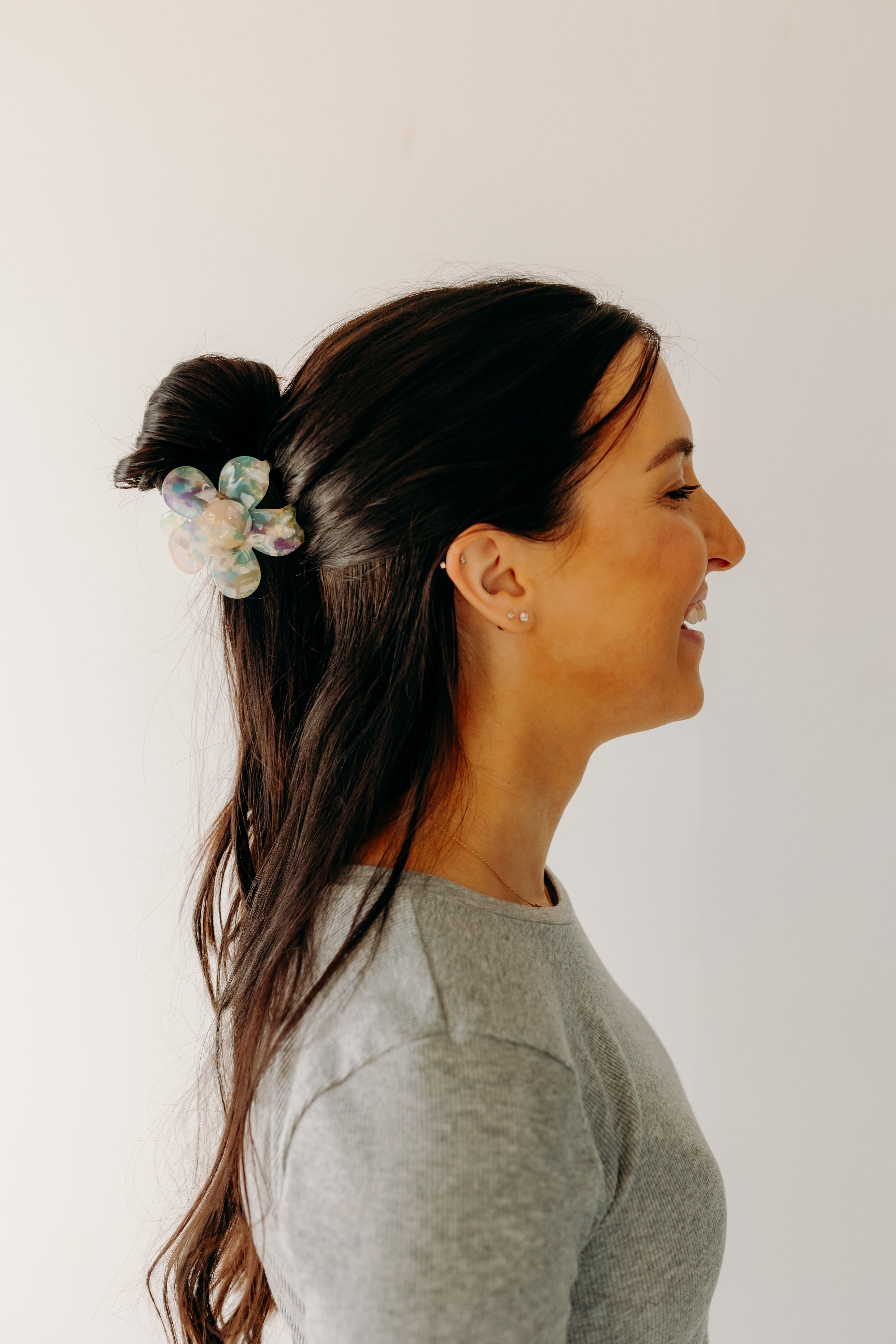 Woman wearing Time to Bloom Lilac Clip in her hair, close-up of flower hair accessory.