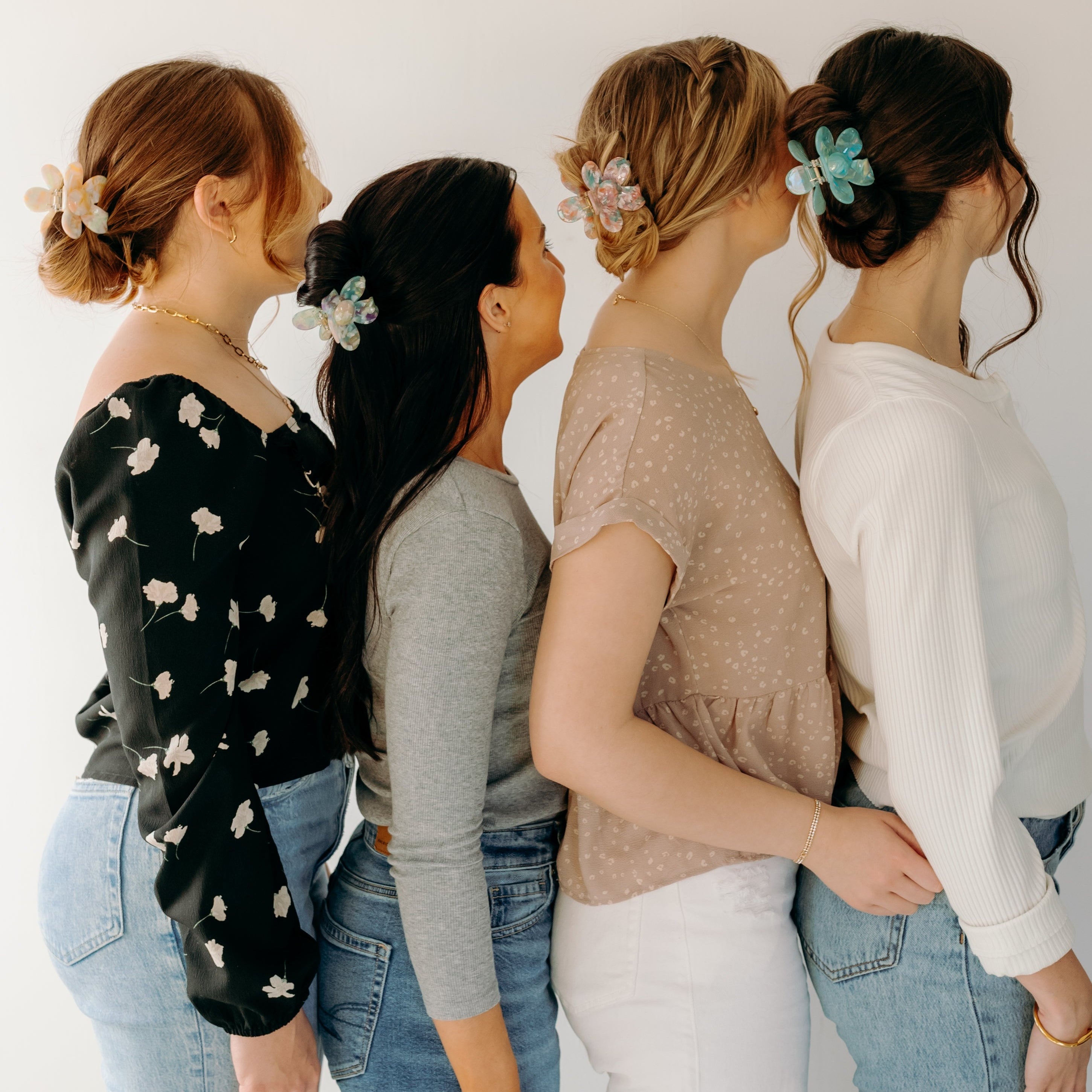 Women wearing Time to Bloom Lilac Clip in their hair, close-up of flower hair accessory.