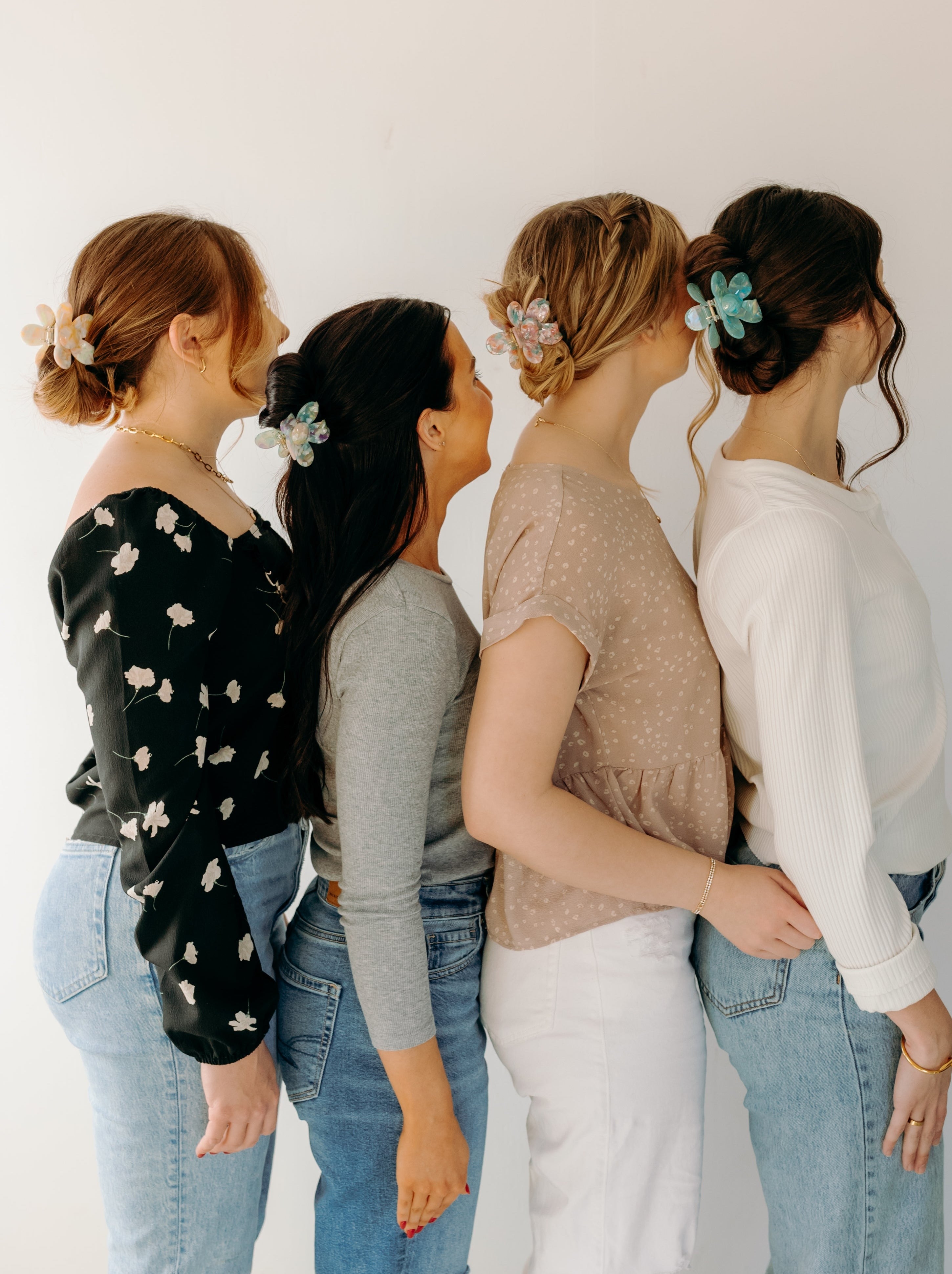 Women wearing Time to Bloom Lilac Clip in their hair, close-up of flower hair accessory.