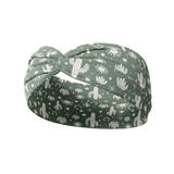 Keeping It Rural headband featuring white cactus designs on a green background. Ultra-stretchy, versatile, sweat-absorbent, and non-slip. Perfect for workouts or daily wear.
