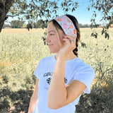 A woman outdoors wearing a Kitchen's Closed Lilac Market Headband, showcasing its versatile twist style and functional design.
