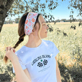 A woman outdoors wearing a Kitchen's Closed Lilac Market Headband, showcasing its versatile twist style and functional design.