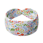 Light blue headband with colorful small floral pattern, ultra-soft poly-knit blend, versatile twist style, sweat absorbent, non-slip, designed in Springfield, MO.