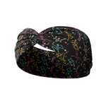 Never Better headband featuring colorful skeletons on black, buttery-soft, ultra-stretchy poly-knit blend. Versatile, non-slip, machine washable, perfect for workouts and daily wear.