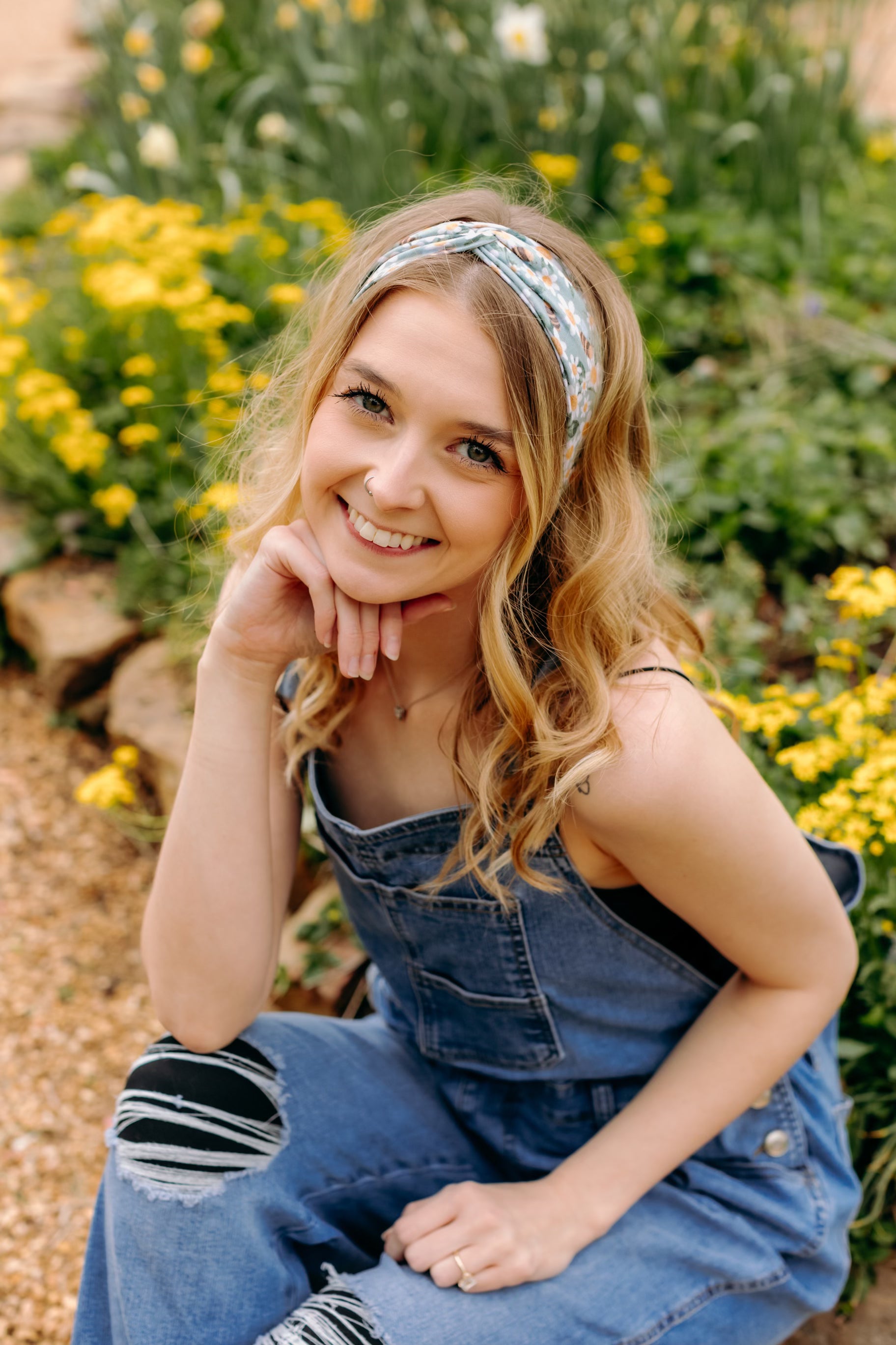 A woman in Lilac Market's Blossom Buddies headband smiles, showcasing its versatile 3-in-1 twist style. Functional, machine washable, and sweat-absorbent for workouts or play.
