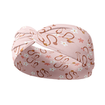 A pink headband with a stethoscope and daisy pattern, designed for confidence and functionality. Features a versatile 3-in-1 twist style, sweat-absorbent double-layer fabric, and a buttery-soft poly-knit blend.