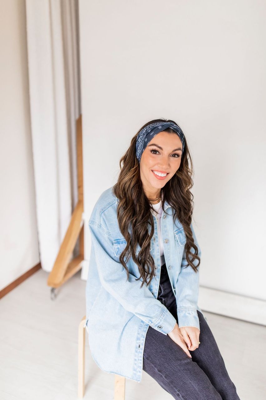 Adult women’s black headband with white paisley bandana print.
