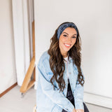 Adult women’s black headband with white paisley bandana print.