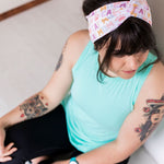 Adult women's white headband with orange, slate, tan, blush and plum pawprints, hearts and words they say "cat mom"