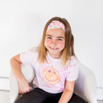 Adult women's peach headband with purple, blue, orange, yellow, green and pink candy hearts with various Valentine's sayings