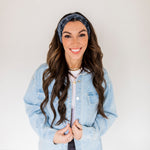 Adult women’s black headband with white paisley bandana print.