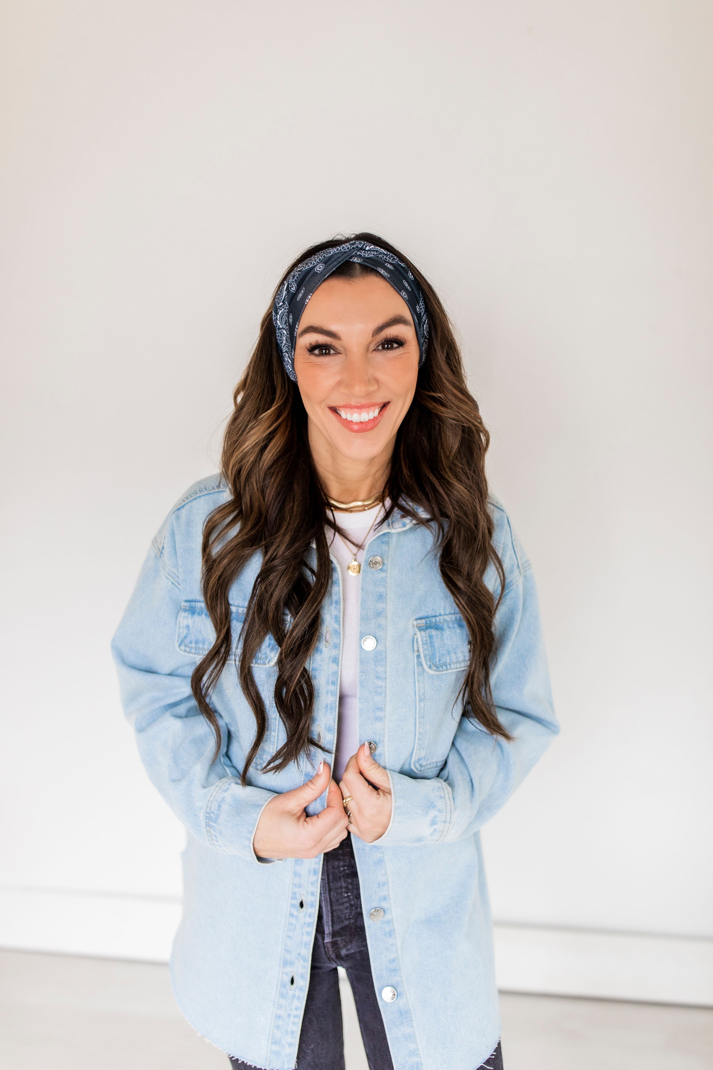 Adult women’s black headband with white paisley bandana print.